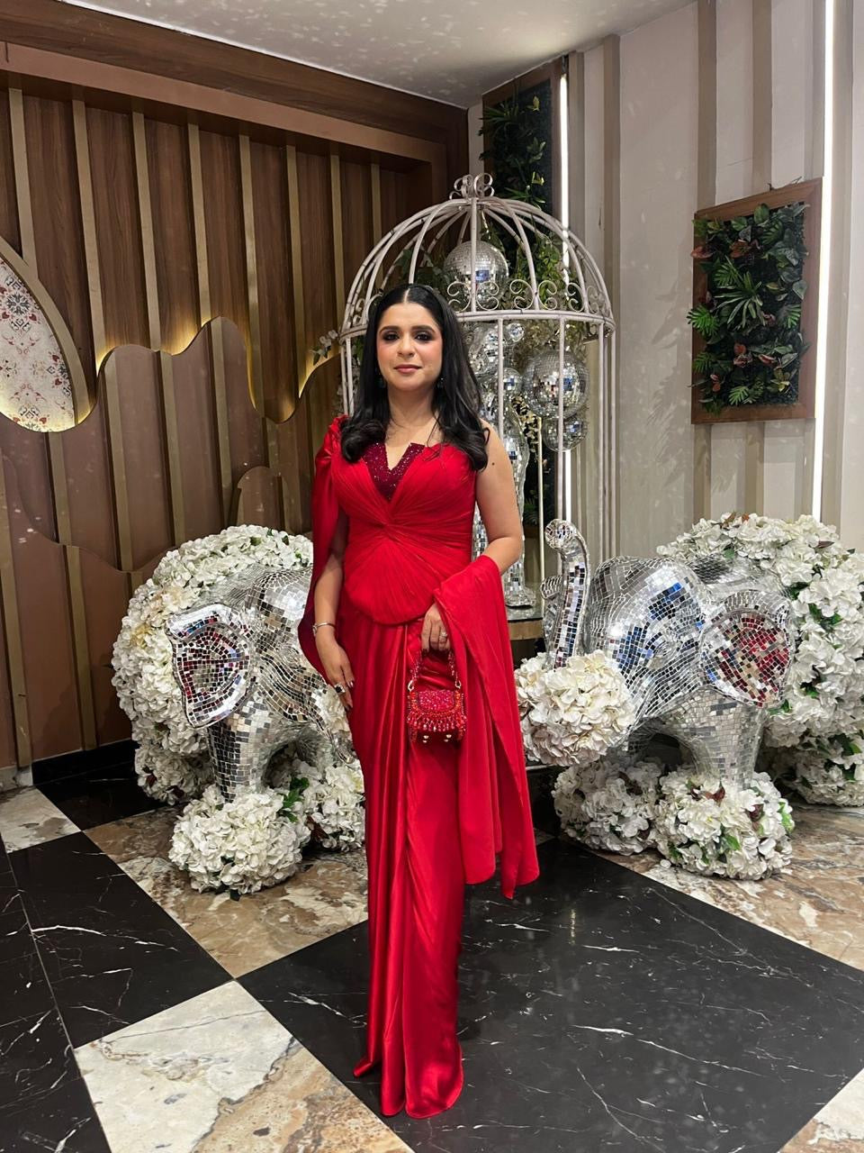Scarlet red crystal corset drape saree worn at an occasion