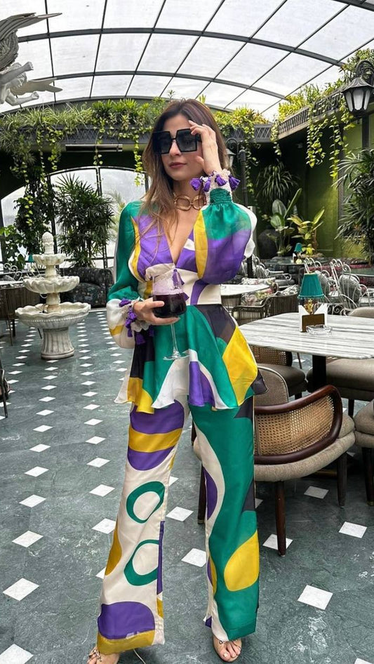 Woman in a colorful outfit standing in an outdoor cafe setting
