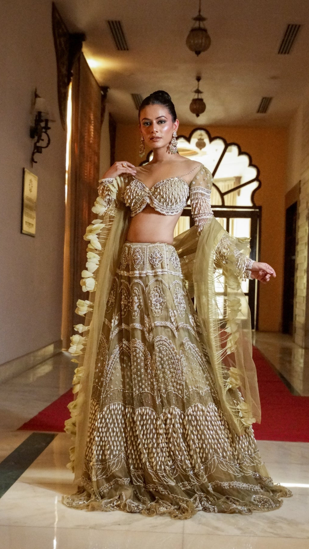 Woman in a traditional outfit standing in an ornate hallway